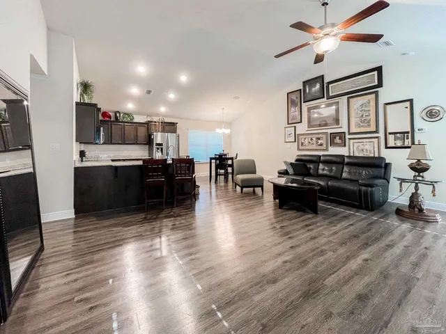 a living room with stainless steel appliances kitchen island granite countertop furniture and a kitchen view