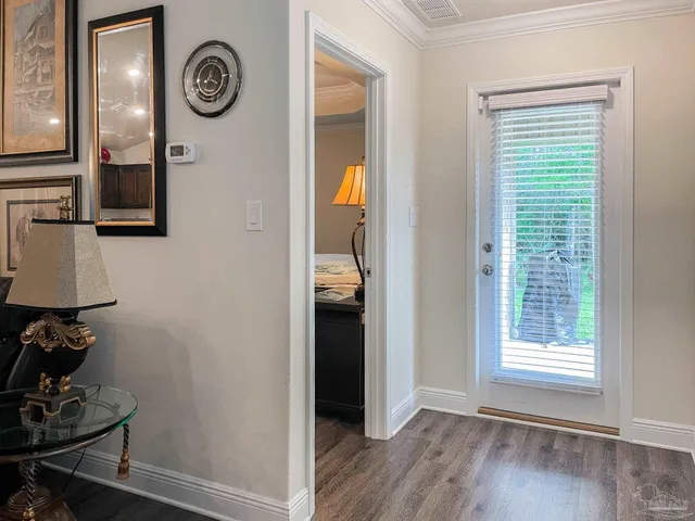 a view of a hallway with wooden floor and closet