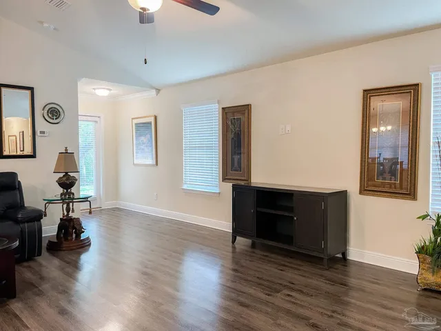 a living room with furniture and wooden floor