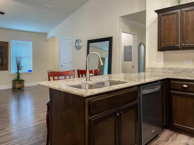 a kitchen with a sink and a wooden cabinets