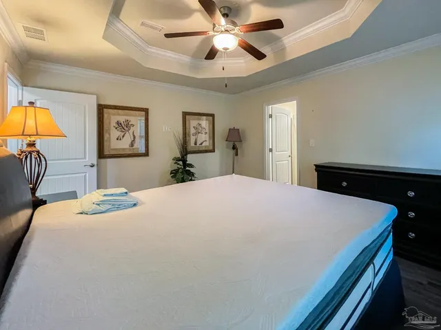 a bedroom with a bed and a chandelier