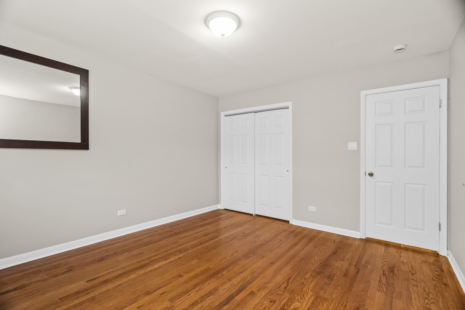617 Case Place, Unit 2 Evanston, IL 60202 - Photo 11 of 13 a view of an empty room with wooden floor and closet