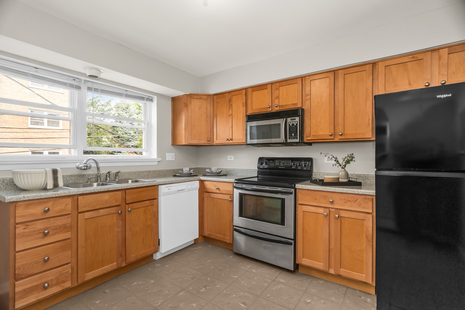 617 Case Place, Unit 2 Evanston, IL 60202 - Photo 6 of 13 a kitchen with stainless steel appliances granite countertop a stove a sink dishwasher a refrigerator and a microwave oven