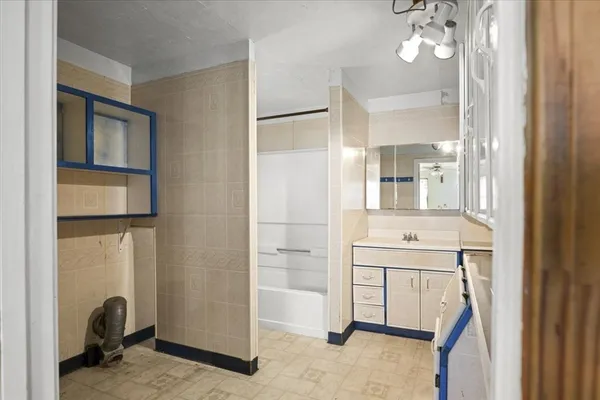 a bathroom with a sink a mirror and a shower