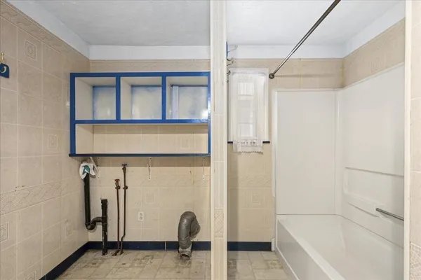 a bathroom with a bathtub and shower