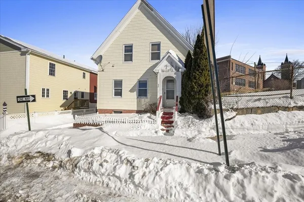a view of a house with snow on the road