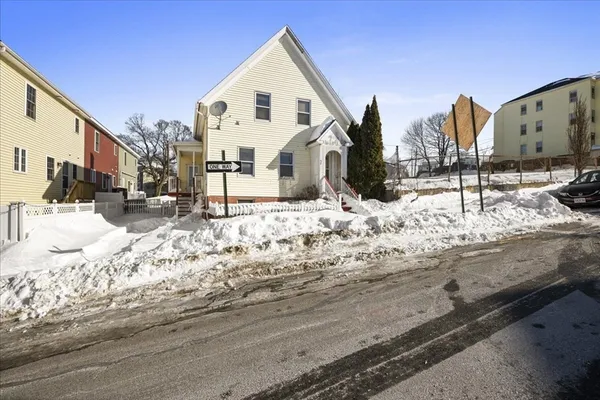 a view of a house with snow on the road