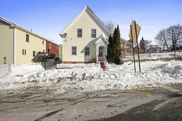 a view of a house with snow on the road