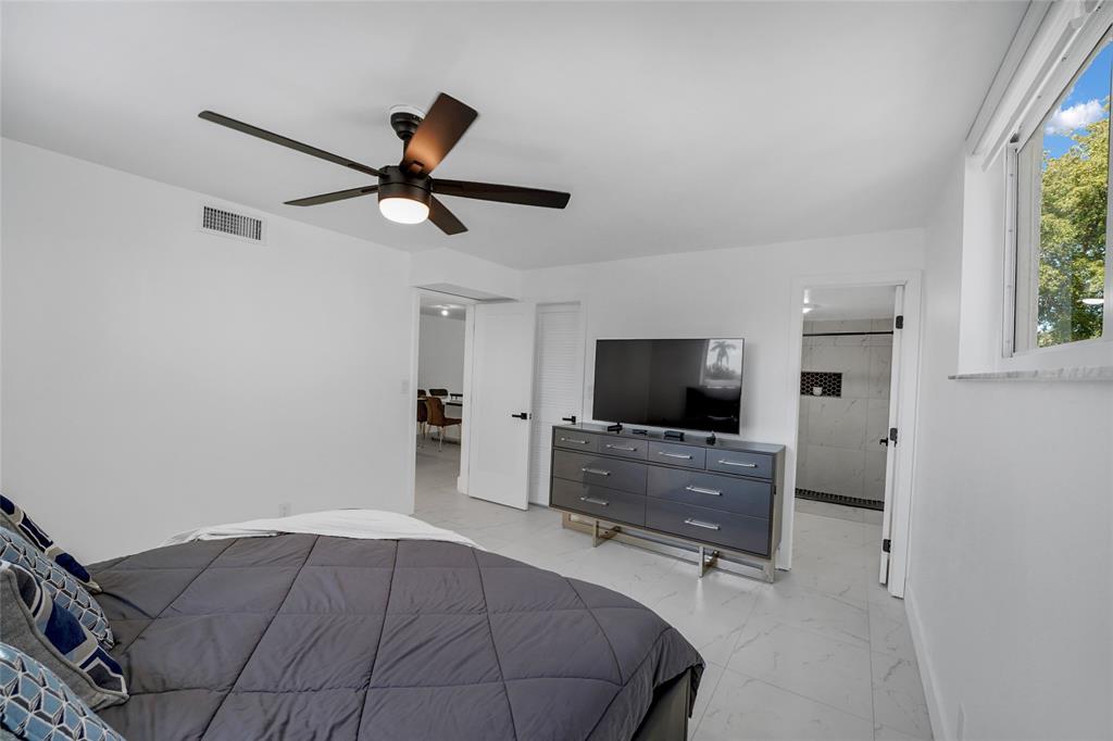 8911 South Hollybrook Boulevard, Unit 201 Pembroke Pines, FL 33025 - Photo 17 of 31 a bedroom with a bed and a flat screen tv