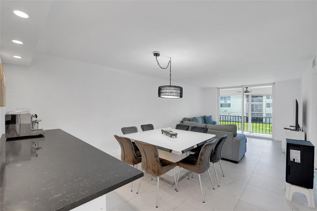 8911 South Hollybrook Boulevard, Unit 201 Pembroke Pines, FL 33025 - Photo 2 of 31 a view of a dining room with furniture