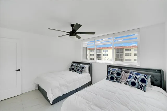 a bedroom with a large bed and a large window