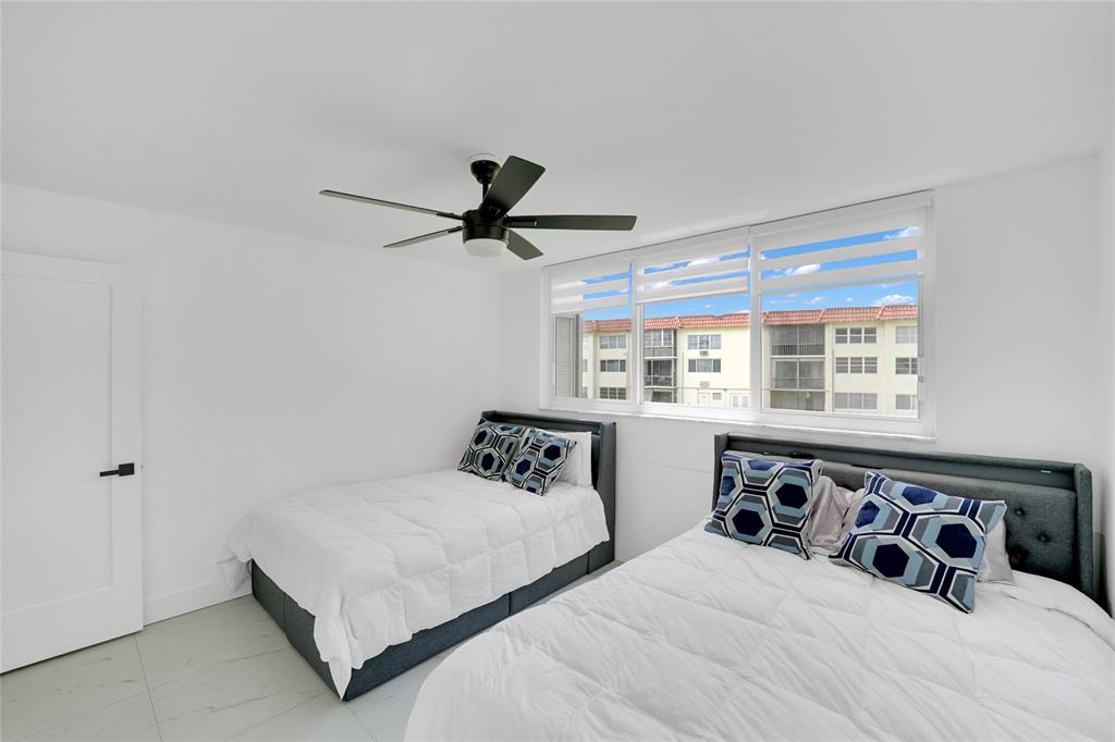 8911 South Hollybrook Boulevard, Unit 201 Pembroke Pines, FL 33025 - Photo 21 of 31 a bedroom with a large bed and a large window