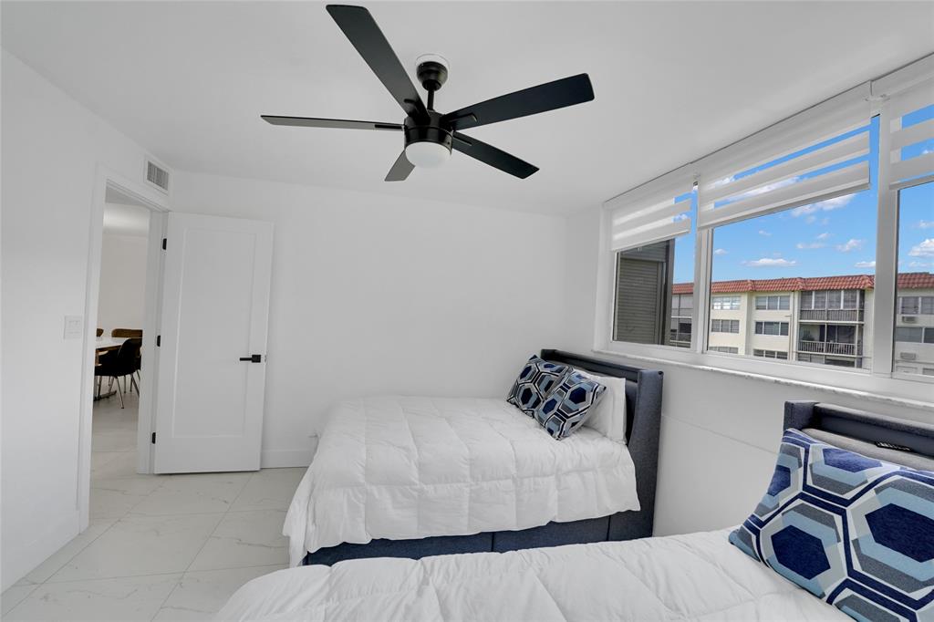 8911 South Hollybrook Boulevard, Unit 201 Pembroke Pines, FL 33025 - Photo 22 of 31 a bedroom with a bed and cabinets