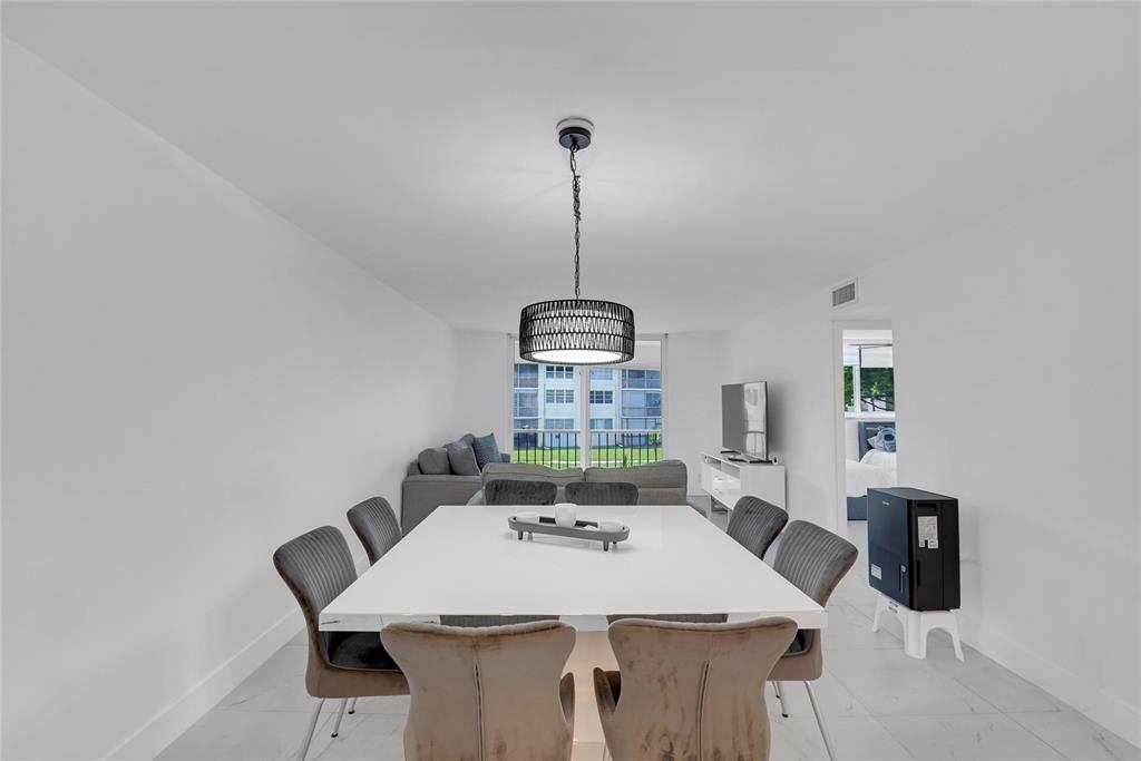 8911 South Hollybrook Boulevard, Unit 201 Pembroke Pines, FL 33025 - Photo 9 of 31 a view of a dining room with furniture