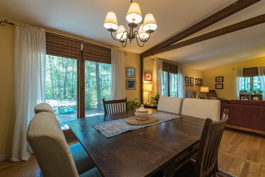 70 Stony Hill Road Amherst, MA 01002 - Photo 11 of 22 a view of a dining room with furniture a chandelier and large windows