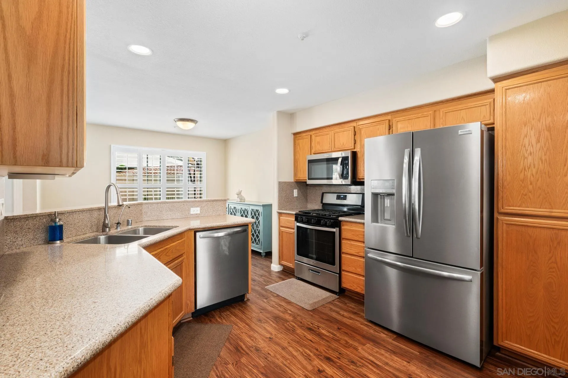 405 Whispering Willow Drive, Unit C Santee, CA 92071 - Photo 1 of 39 a kitchen with a refrigerator a sink dishwasher with a stove and wooden floor