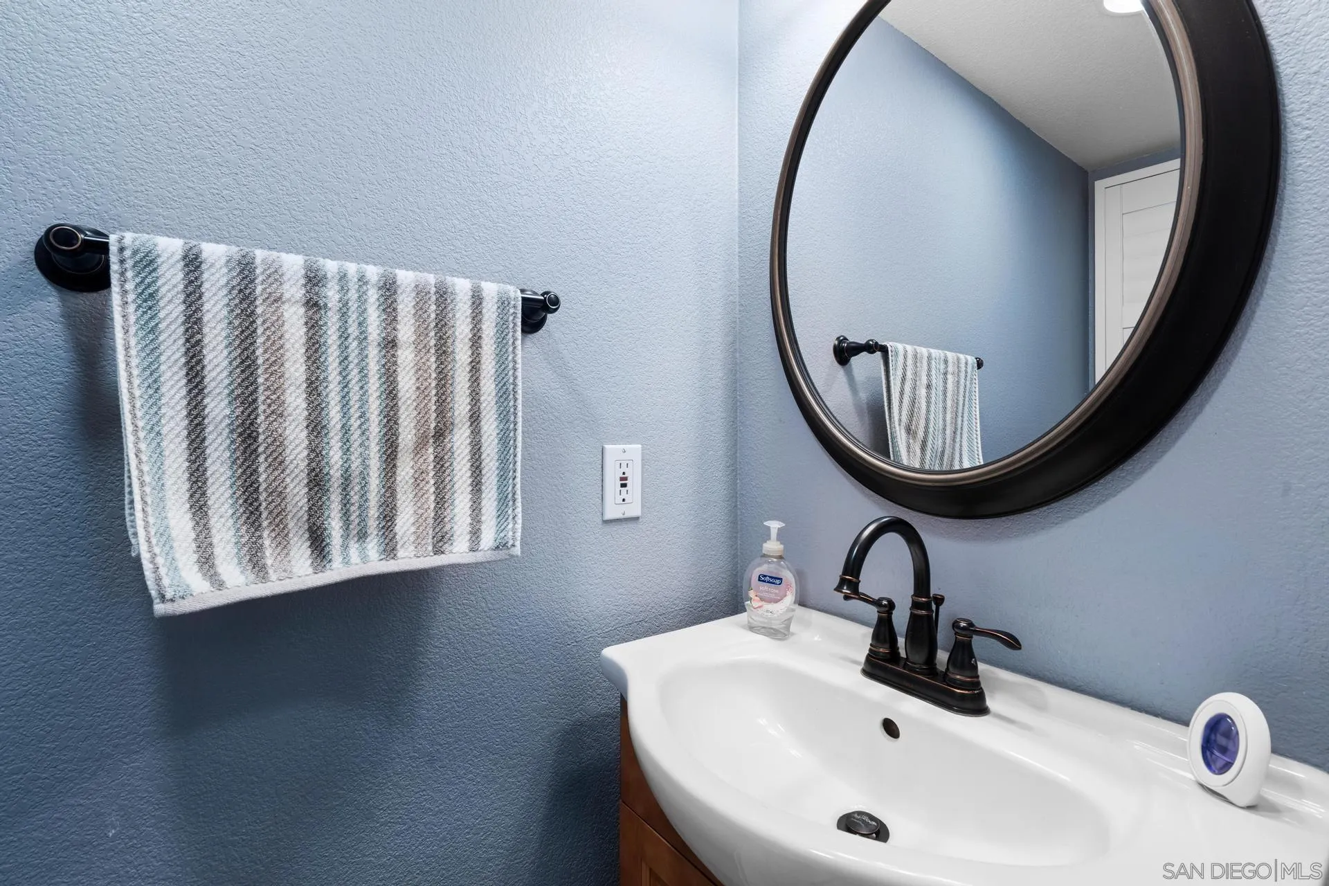 405 Whispering Willow Drive, Unit C Santee, CA 92071 - Photo 12 of 39 a bathroom with a sink and a mirror