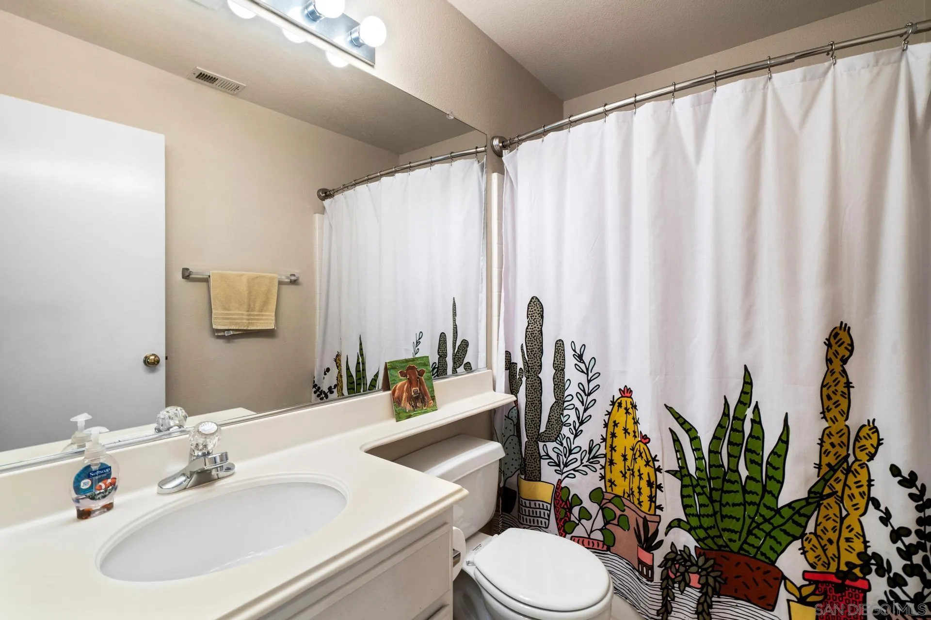 405 Whispering Willow Drive, Unit C Santee, CA 92071 - Photo 13 of 39 a bathroom with a sink a mirror and a toilet