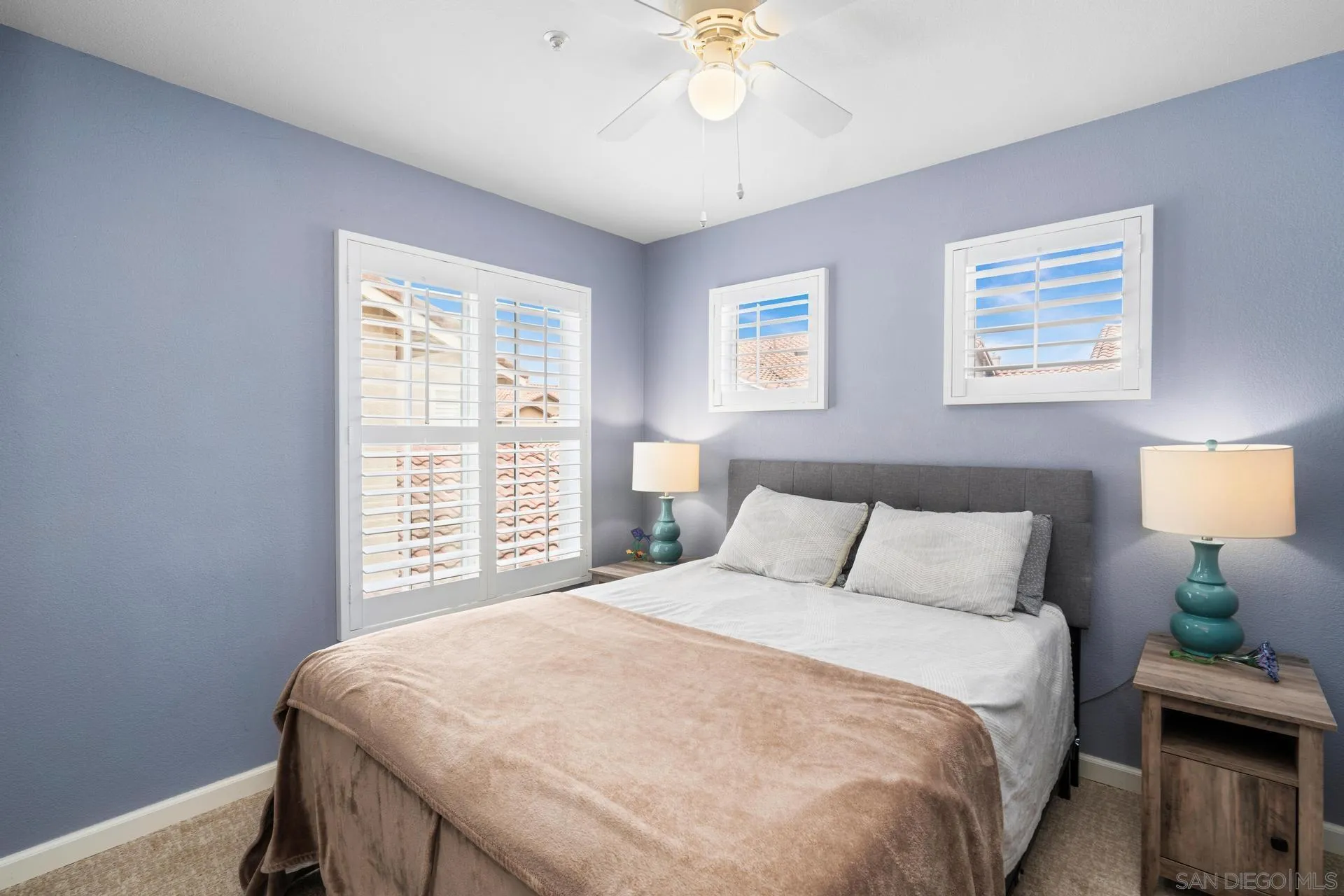 405 Whispering Willow Drive, Unit C Santee, CA 92071 - Photo 14 of 39 a bedroom with a bed and a chandelier