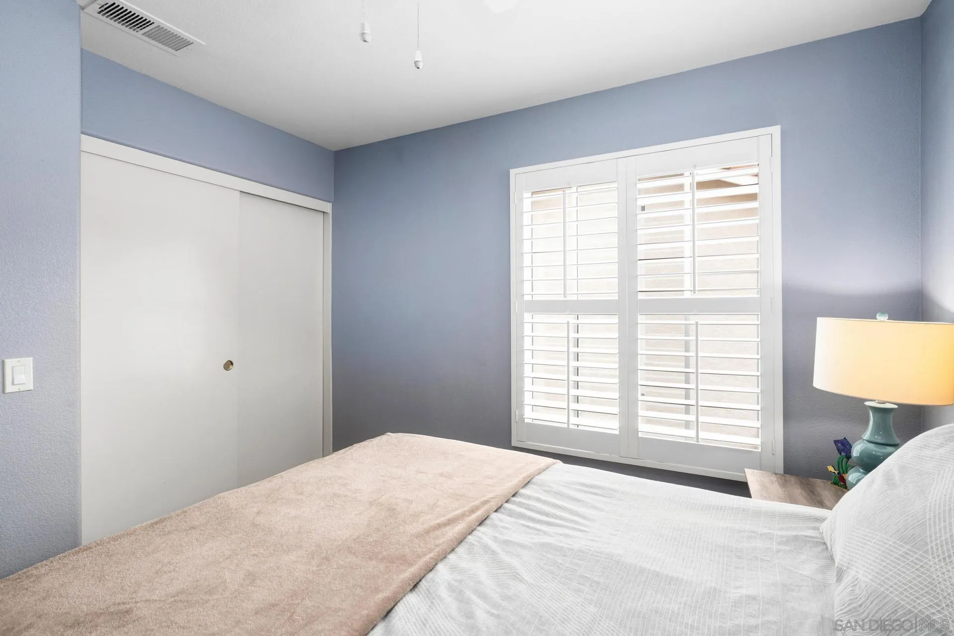 405 Whispering Willow Drive, Unit C Santee, CA 92071 - Photo 15 of 39 a bedroom with a bed and a window