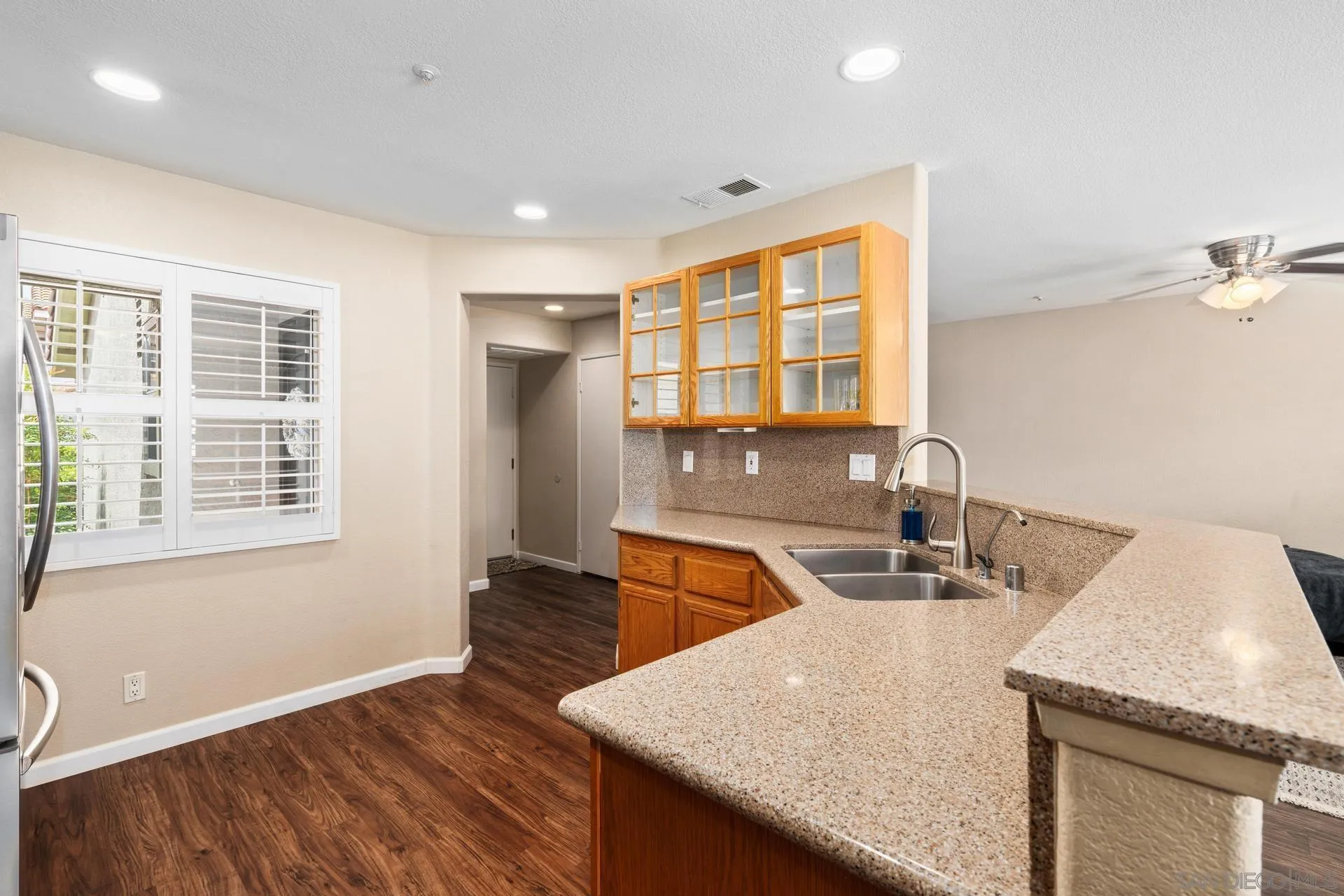 405 Whispering Willow Drive, Unit C Santee, CA 92071 - Photo 2 of 39 a kitchen with granite countertop a sink and a window