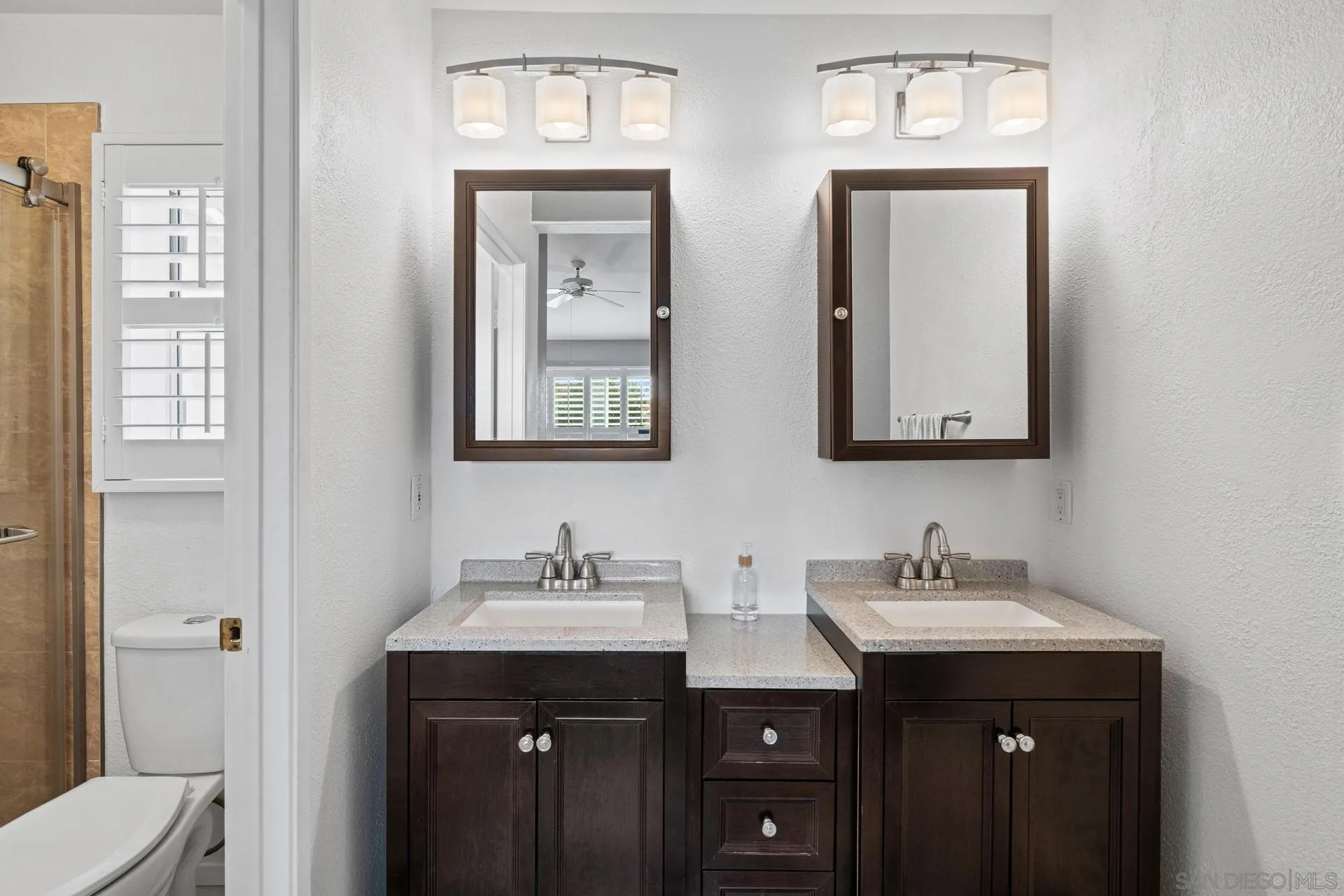 405 Whispering Willow Drive, Unit C Santee, CA 92071 - Photo 24 of 39 a bathroom with double sink and two mirror