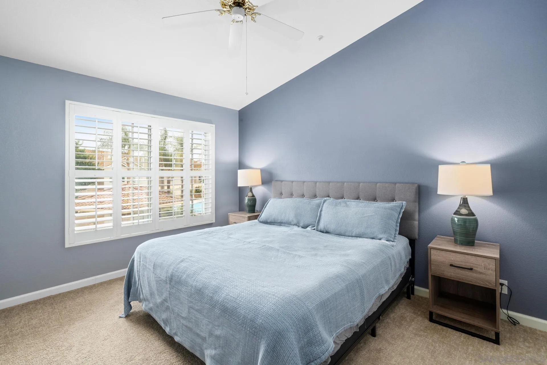 405 Whispering Willow Drive, Unit C Santee, CA 92071 - Photo 27 of 39 a bedroom with a bed and a chandelier