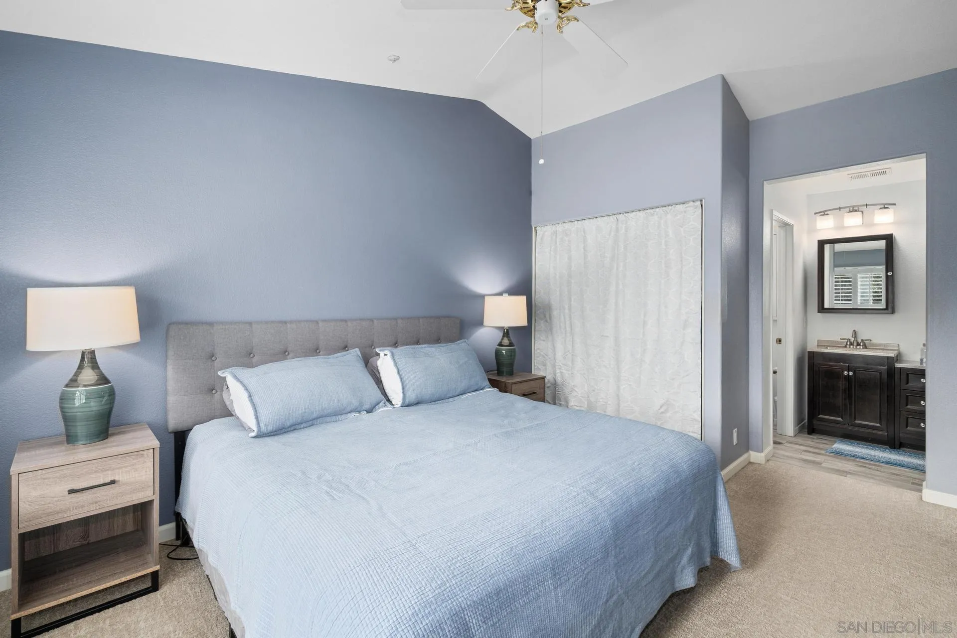 405 Whispering Willow Drive, Unit C Santee, CA 92071 - Photo 28 of 39 a bedroom with a bed and a chandelier