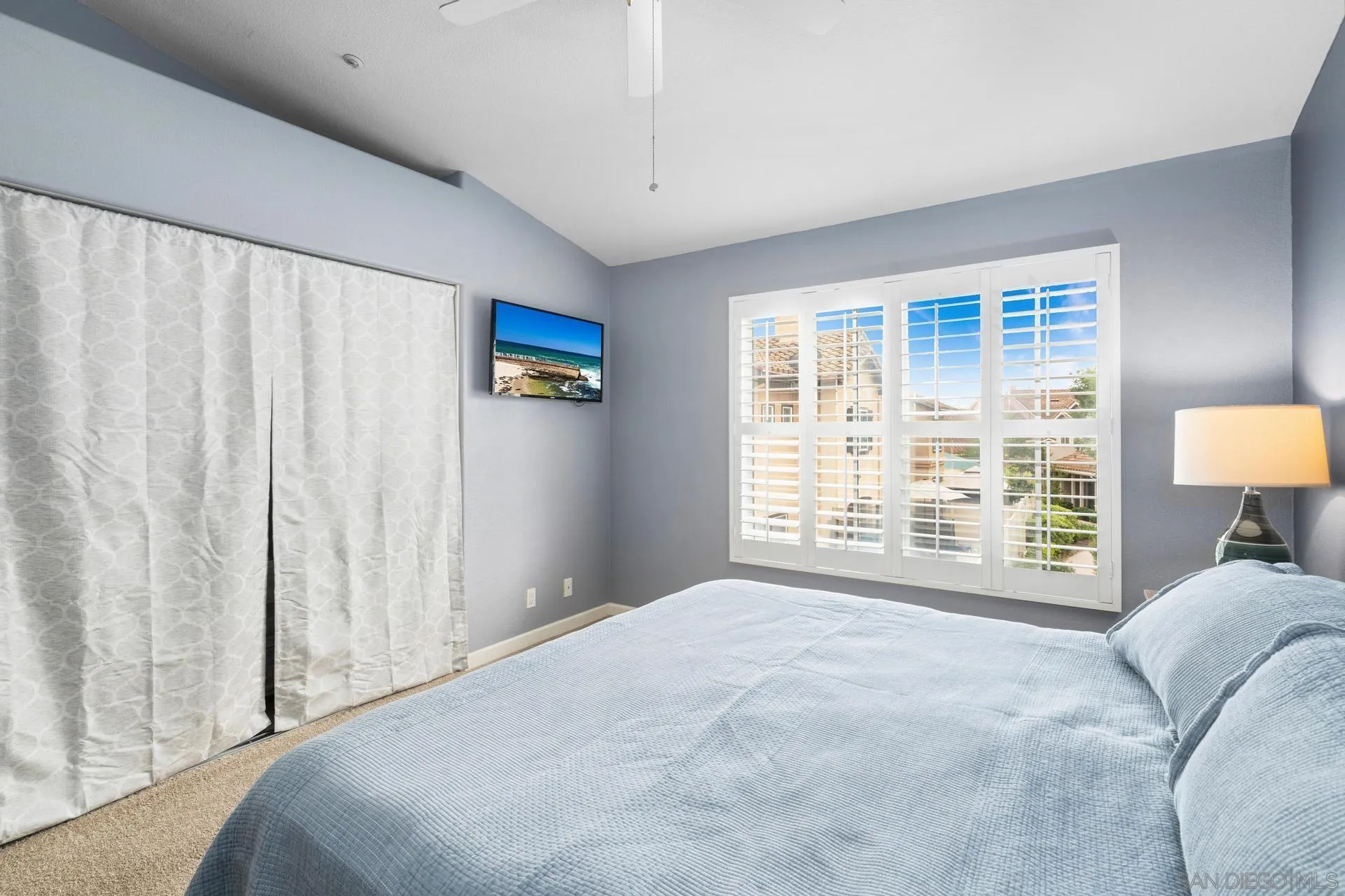405 Whispering Willow Drive, Unit C Santee, CA 92071 - Photo 29 of 39 a bedroom with a bed and a lamp with the window
