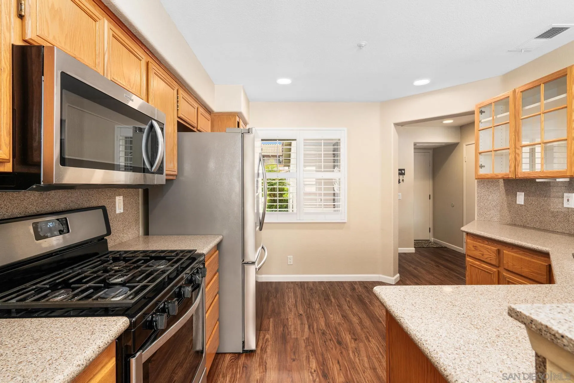 405 Whispering Willow Drive, Unit C Santee, CA 92071 - Photo 3 of 39 a kitchen with stainless steel appliances granite countertop a stove and a sink