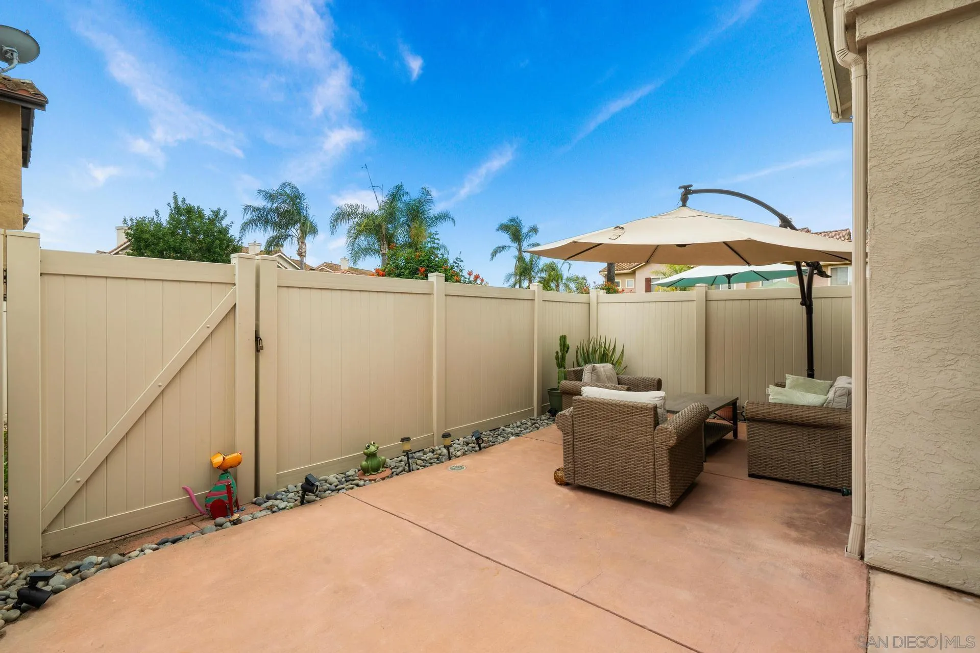405 Whispering Willow Drive, Unit C Santee, CA 92071 - Photo 31 of 39 a backyard of a house with table and chairs