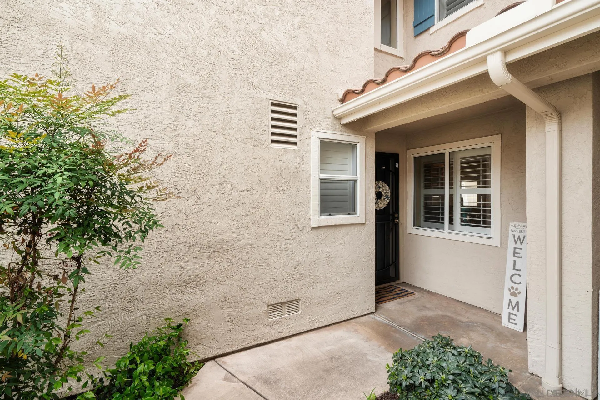 405 Whispering Willow Drive, Unit C Santee, CA 92071 - Photo 34 of 39 a view of a brick house with a large windows