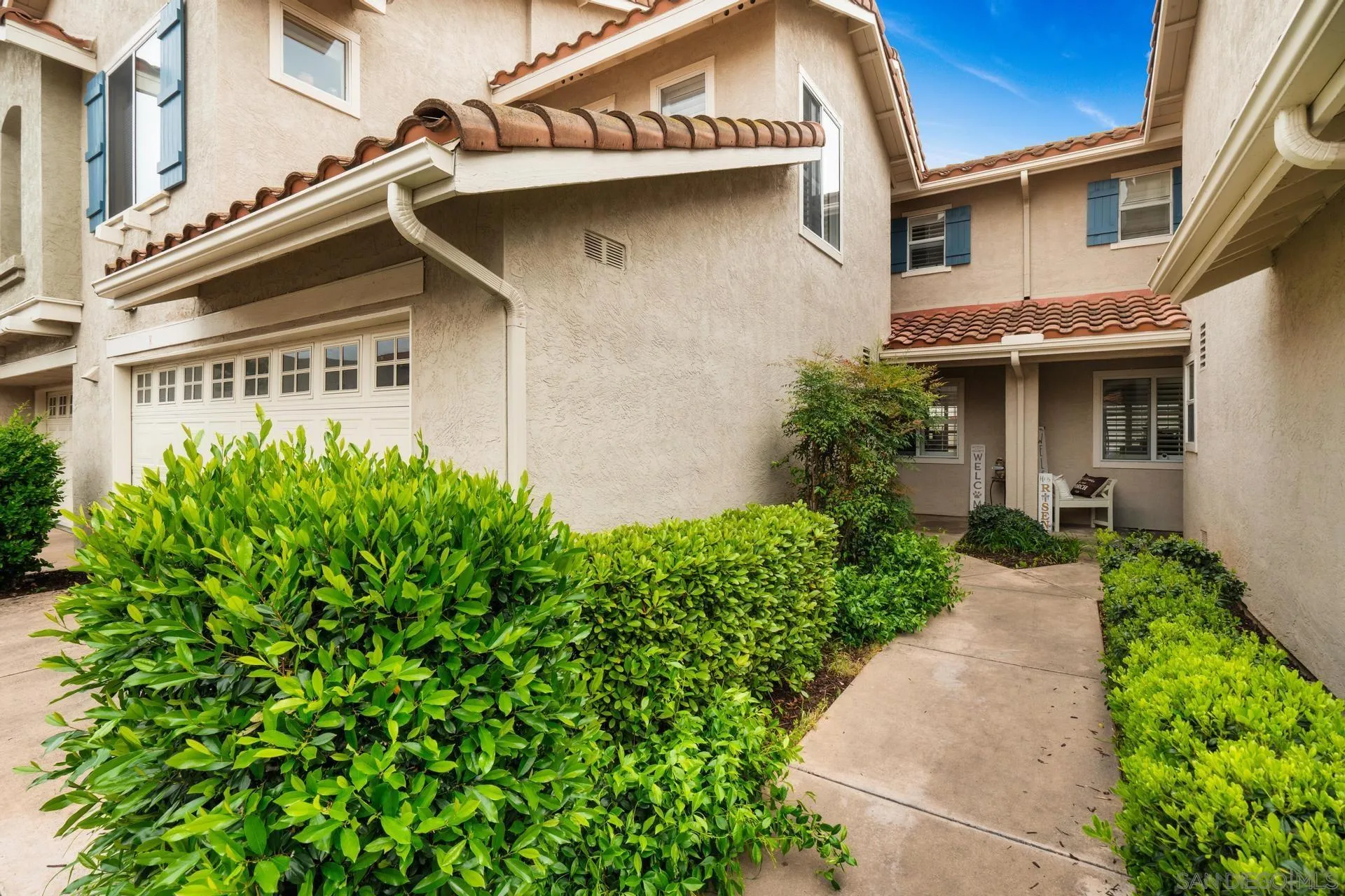 405 Whispering Willow Drive, Unit C Santee, CA 92071 - Photo 35 of 39 a front view of a house with garden