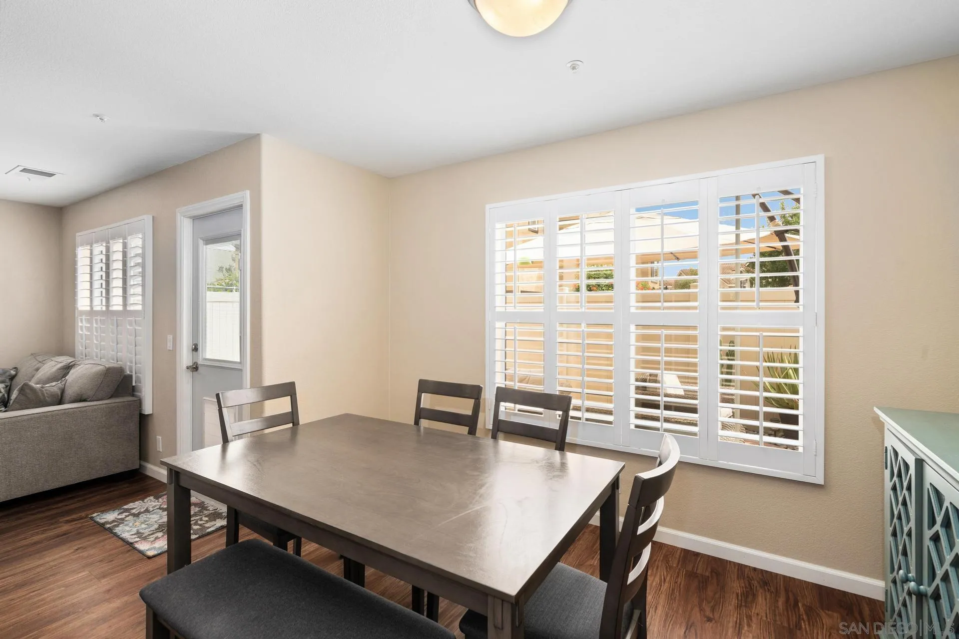 405 Whispering Willow Drive, Unit C Santee, CA 92071 - Photo 4 of 39 a view of a dining room with furniture window and wooden floor