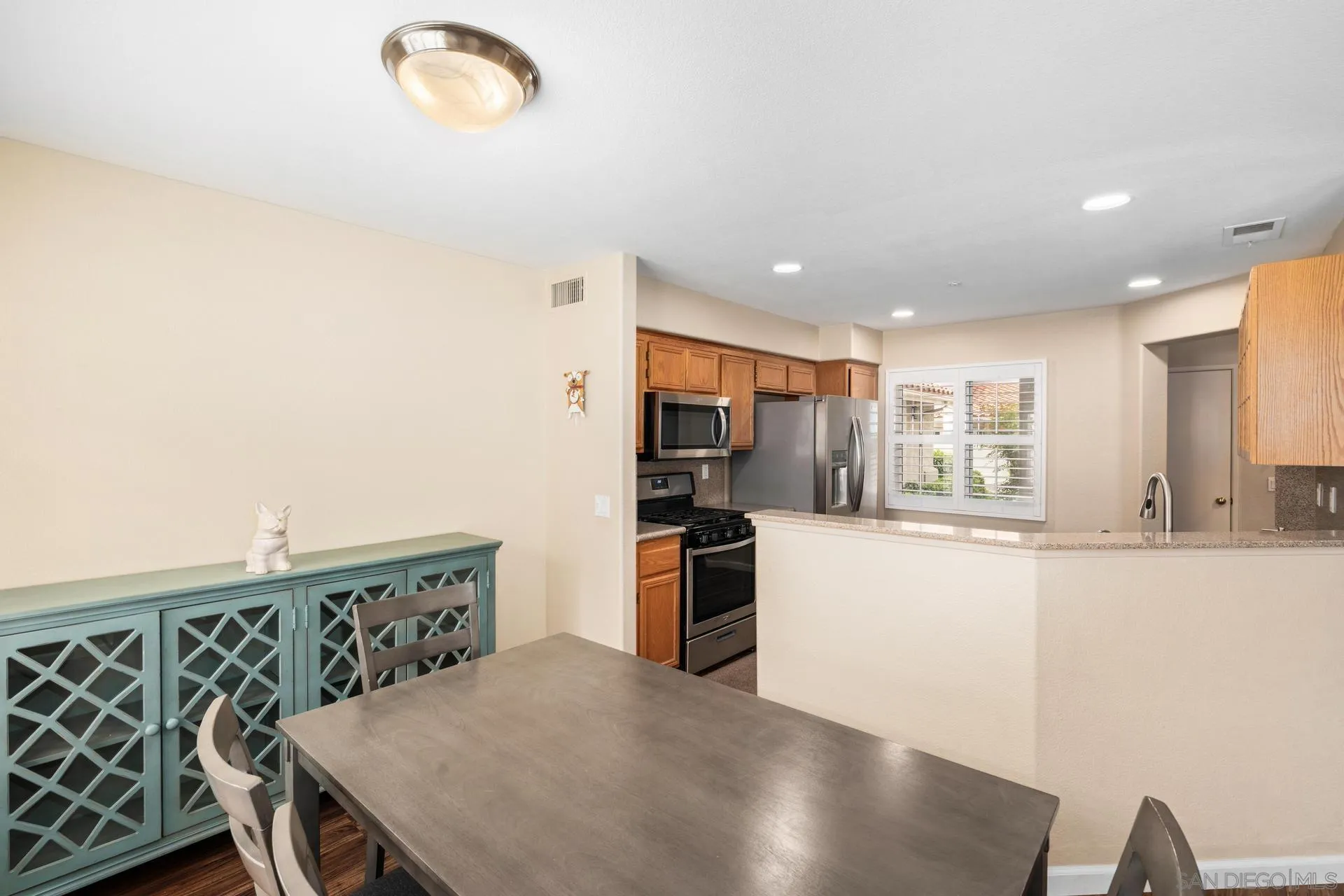 405 Whispering Willow Drive, Unit C Santee, CA 92071 - Photo 6 of 39 a kitchen with stainless steel appliances granite countertop a stove a sink a refrigerator and a refrigerator