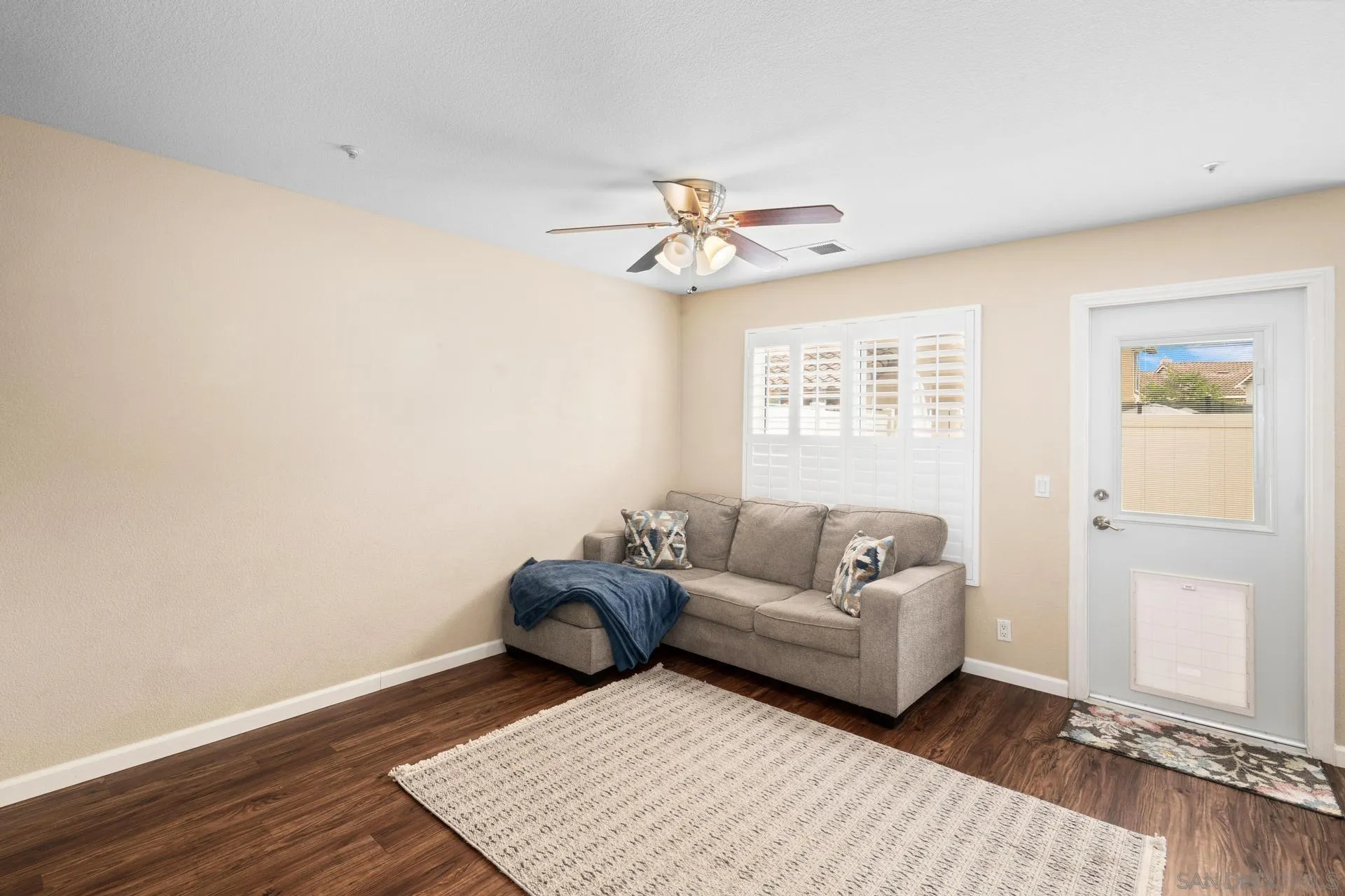405 Whispering Willow Drive, Unit C Santee, CA 92071 - Photo 10 of 39 a living room with a couch and a window