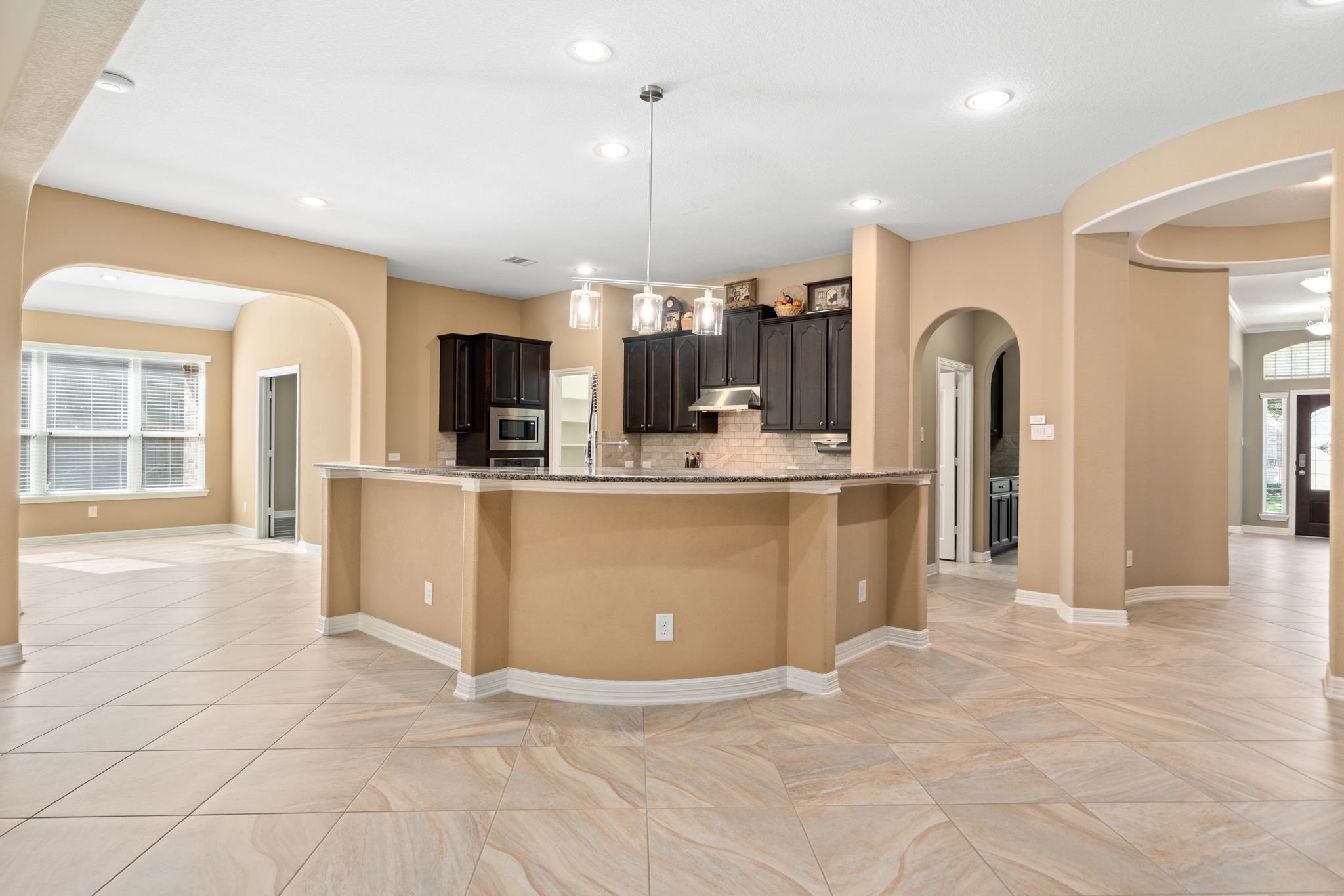 12514 Randy Riley Way Tomball, TX 77377 - Photo 11 of 44 a view of a kitchen with kitchen island stainless steel appliances cabinets a sink and a counter top space