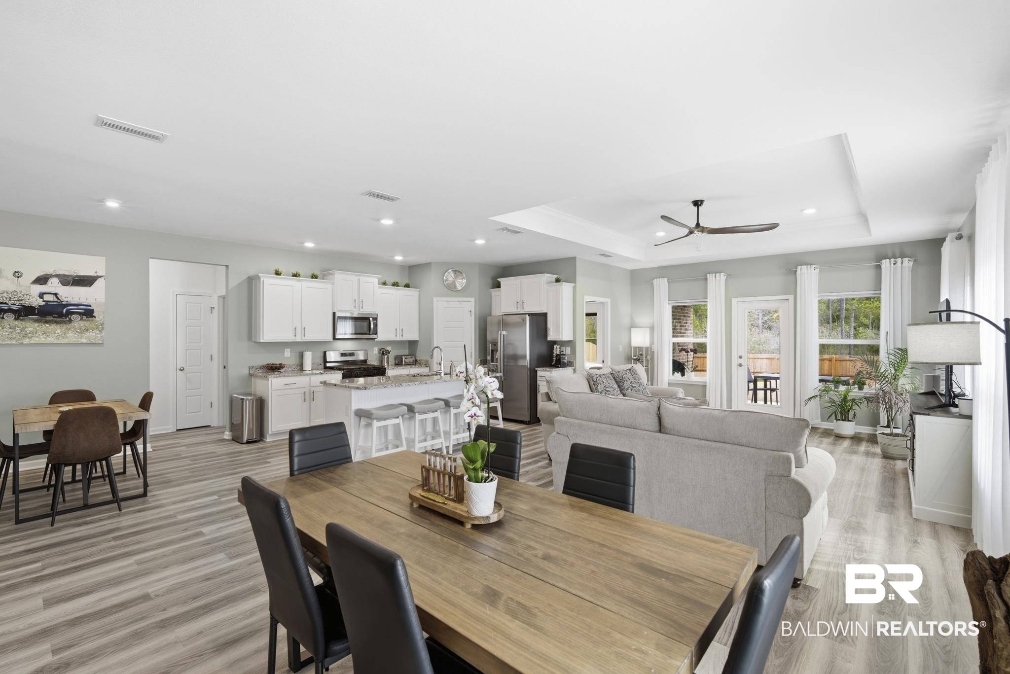 13887 Antler Hl Road Daphne, AL 36527 - Photo 11 of 50 Dining area with a ceiling fan, light wood finished floors, a raised ceiling, and recessed lighting