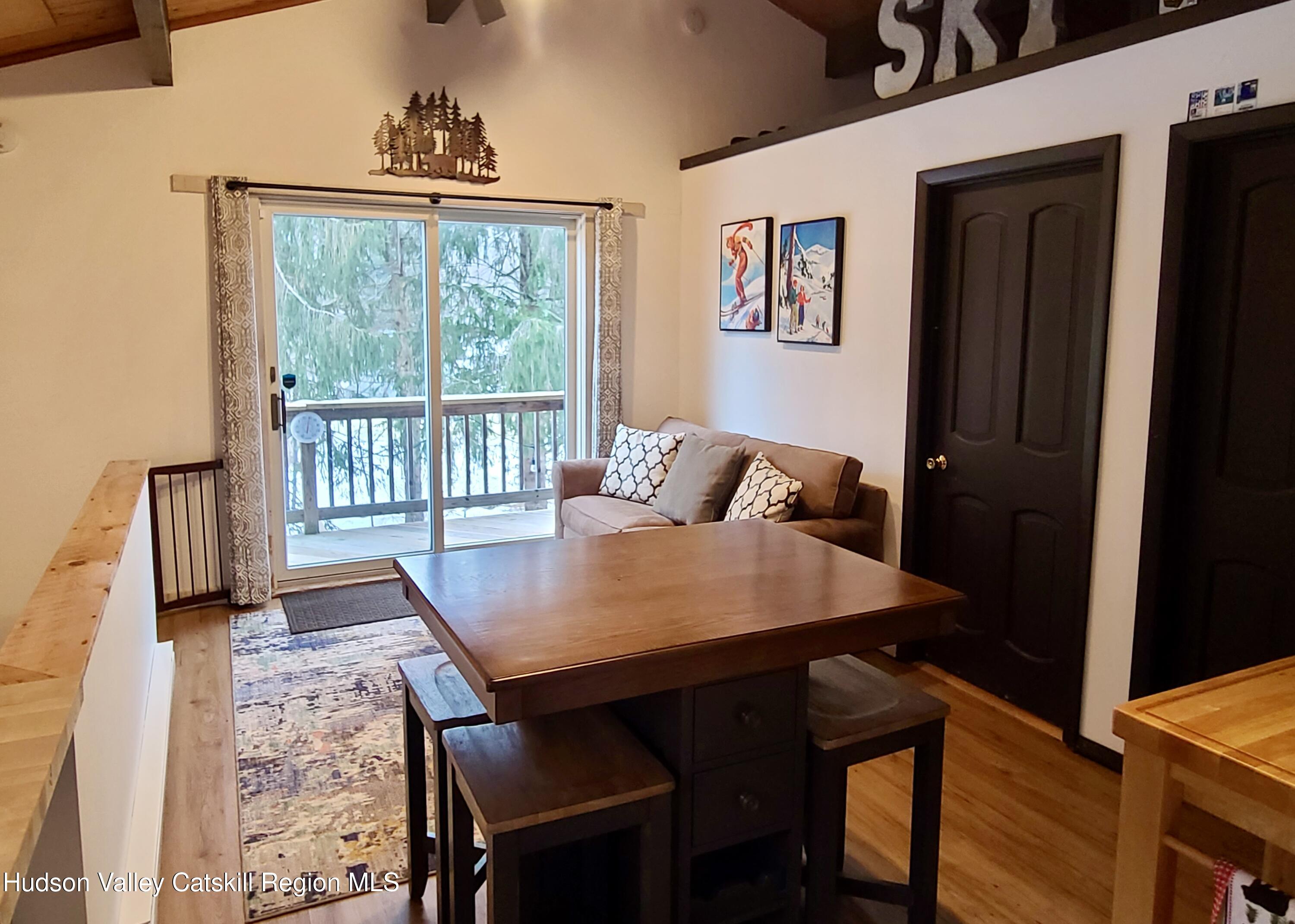 11 Rose Mountain Road Pine Hill, NY 12465 - Photo 13 of 26 a view of a dining room with furniture window and wooden floor