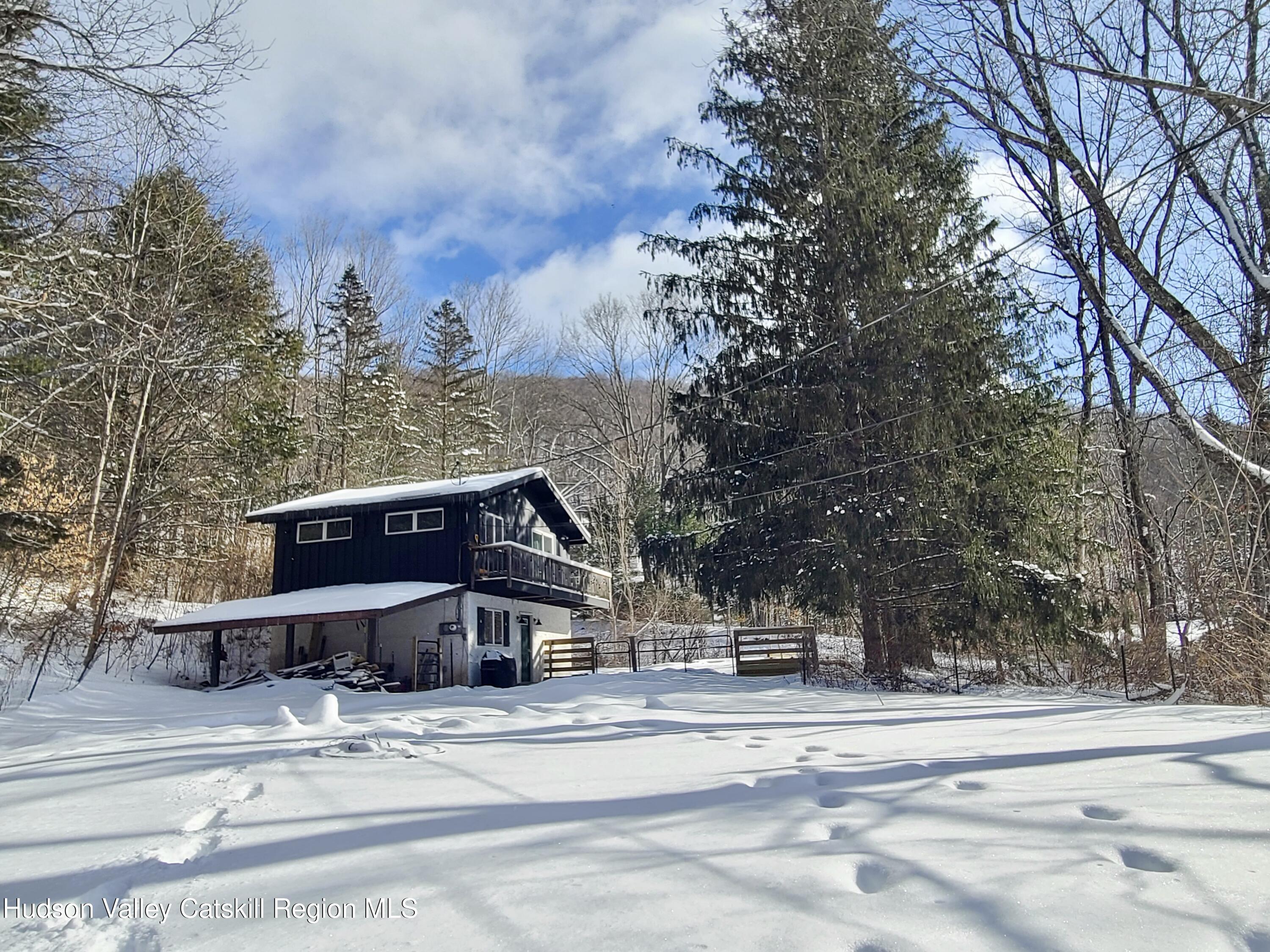11 Rose Mountain Road Pine Hill, NY 12465 - Photo 5 of 26 front view of a house with a bench and trees