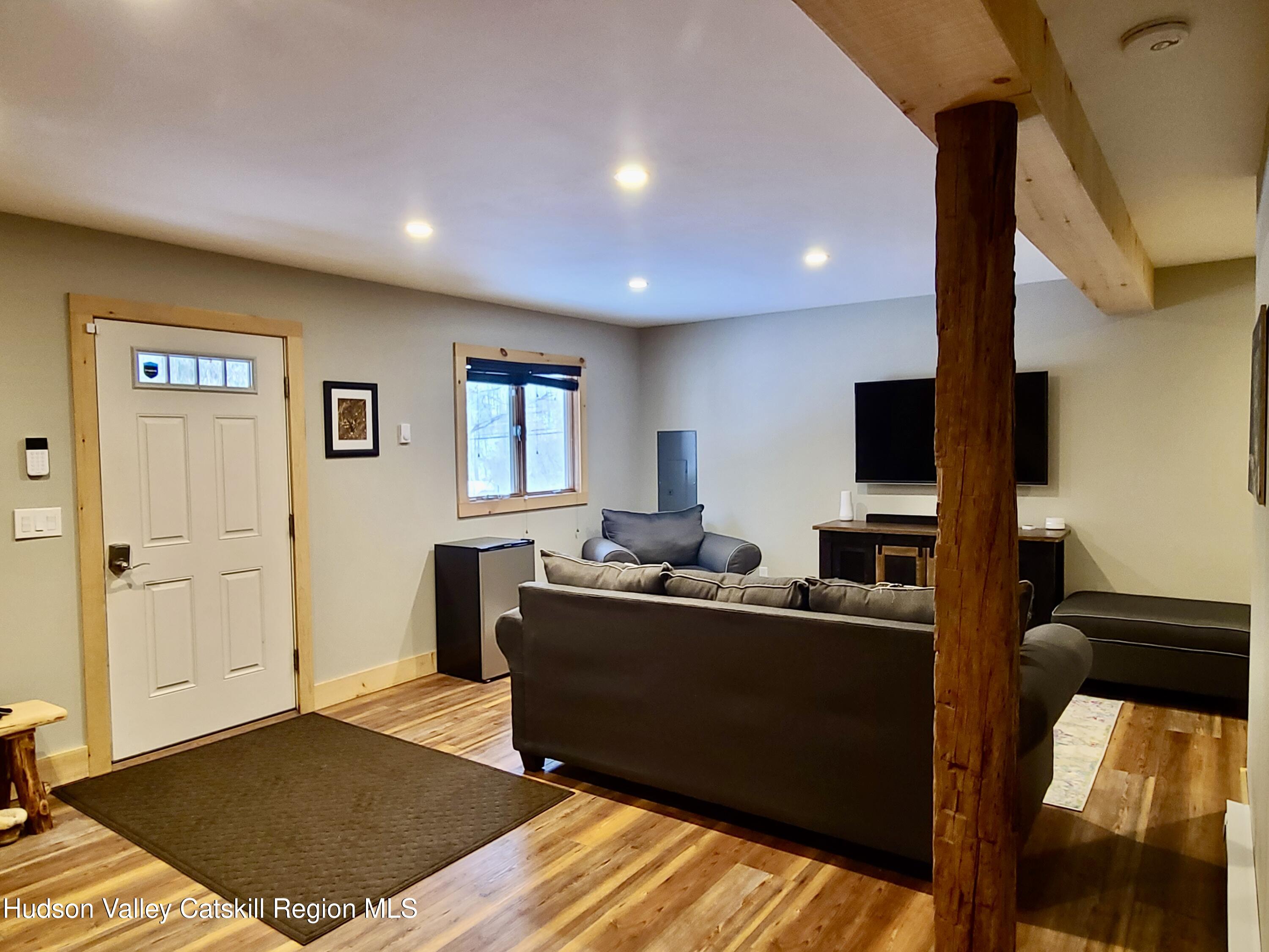 11 Rose Mountain Road Pine Hill, NY 12465 - Photo 7 of 26 a living room with furniture and a flat screen tv