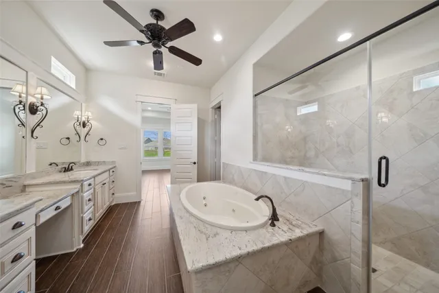 a bathroom with a granite countertop sink a toilet a mirror and shower