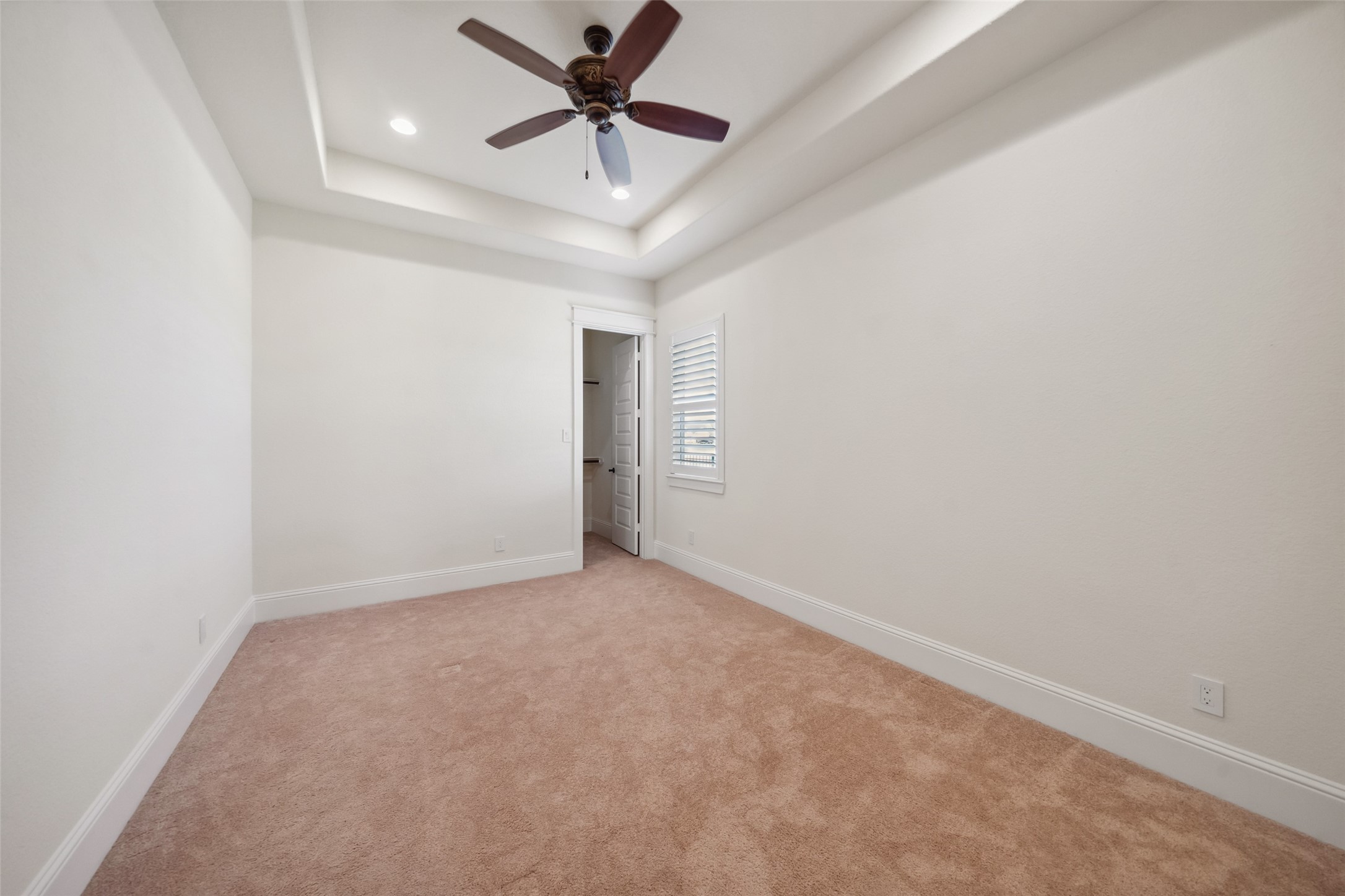 2149 Rope Maker Road Conroe, TX 77384 - Photo 18 of 45 an empty room with a chandelier fan and windows