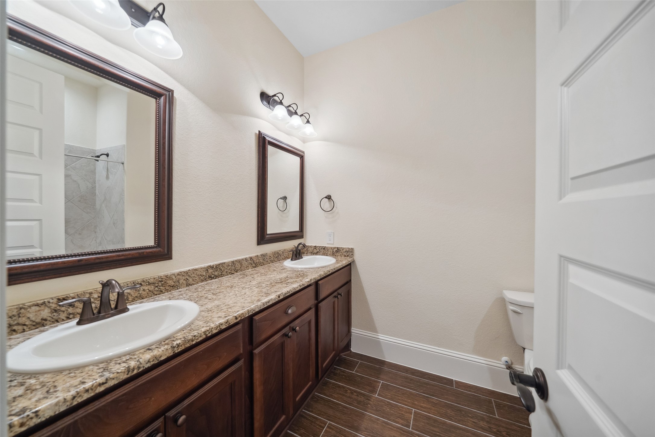 2149 Rope Maker Road Conroe, TX 77384 - Photo 19 of 45 a bathroom with a granite countertop sink and a mirror