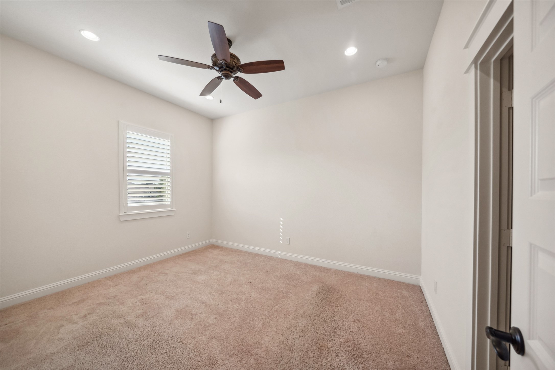 2149 Rope Maker Road Conroe, TX 77384 - Photo 20 of 45 an empty room with windows and fan