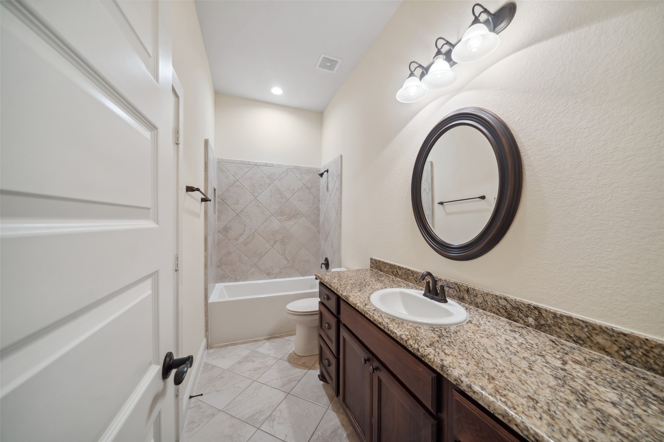 2149 Rope Maker Road Conroe, TX 77384 - Photo 21 of 45 a bathroom with a granite countertop sink a mirror and a bathtub