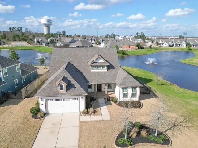 an aerial view of a house with a lake view
