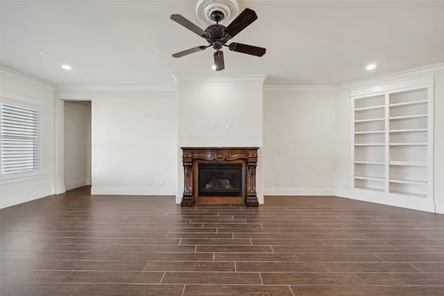 a view of an empty room with a window and a fireplace