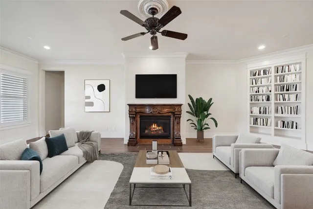 a living room with furniture a fireplace and a flat screen tv