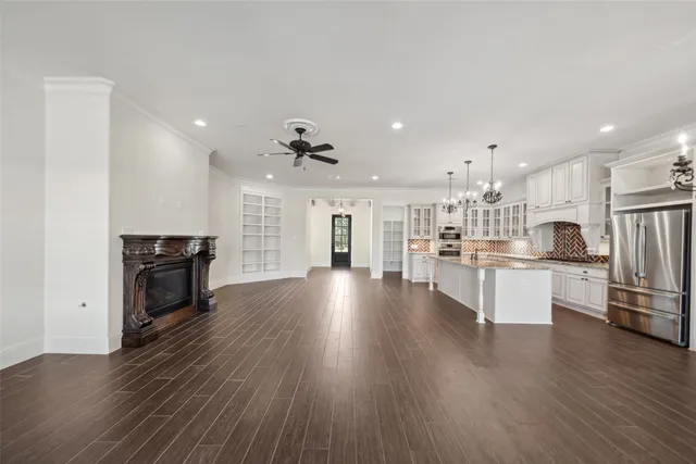 a view of kitchen with refrigerator microwave and stove top oven